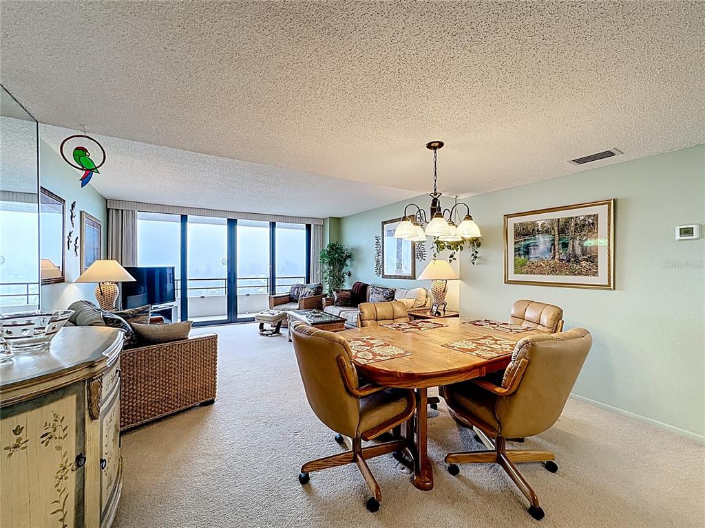 6415 Midnight Pass Road, Unit 705 Sarasota, FL 34242 - Photo 10 of 44 a dining room with furniture and window