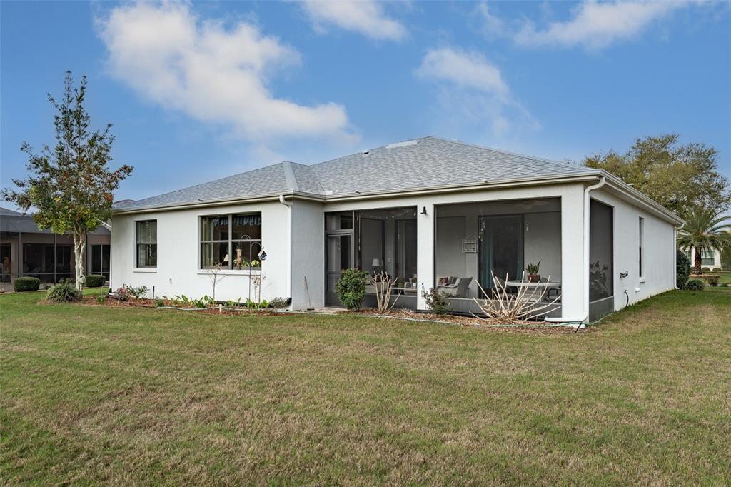 15969 Southwest 14th Avenue Road Ocala, FL 34473 - Photo 34 of 46 a front view of house with yard outdoor seating and barbeque oven