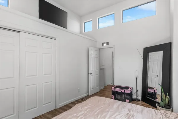 a bedroom with a bed and a tv on the dresser