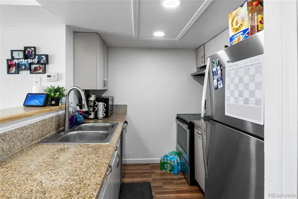 a kitchen with sink refrigerator and window