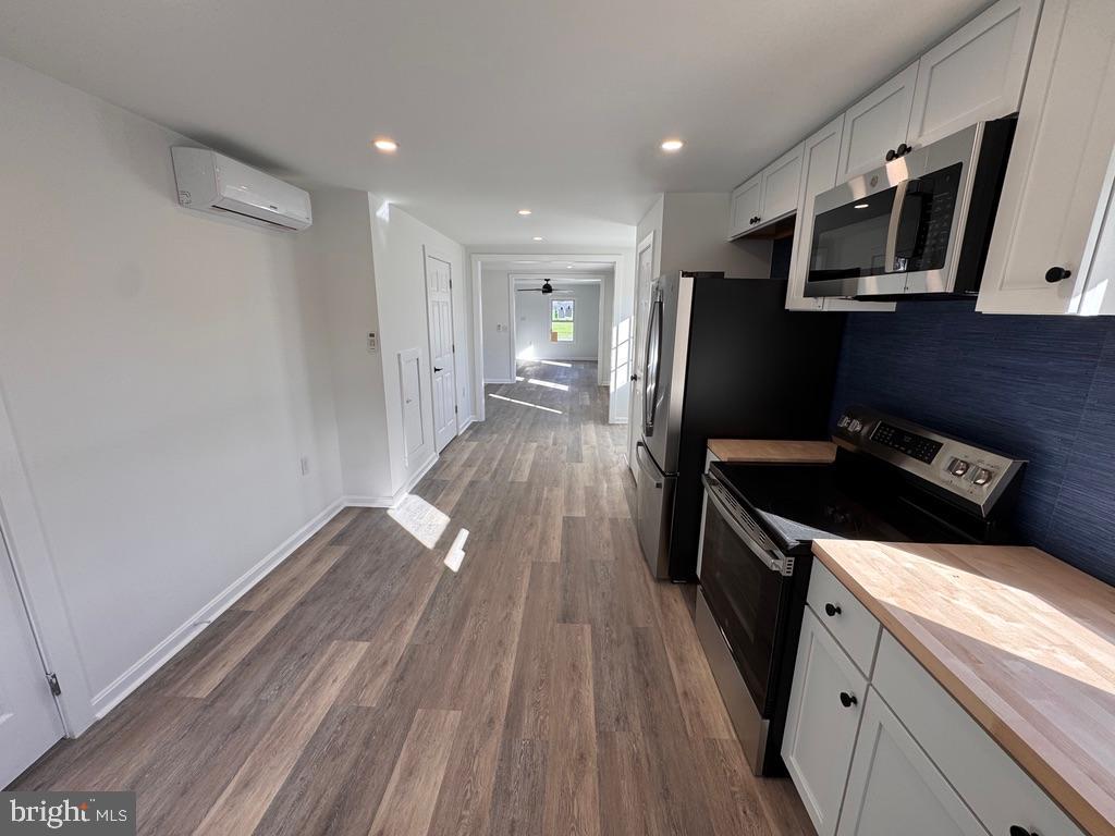 229 Oldtown Road Goldsboro, MD 21636 - Photo 12 of 27 a kitchen with wooden floors and stainless steel appliances
