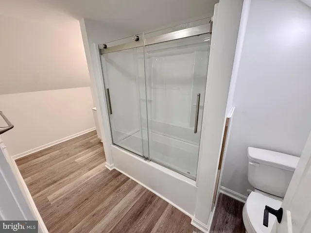 a bathroom with a shower and toilet
