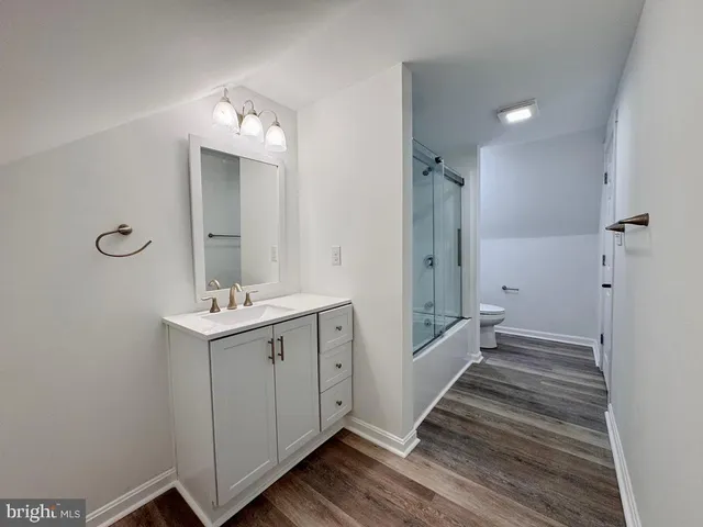 a bathroom with a sink a large mirror and shower