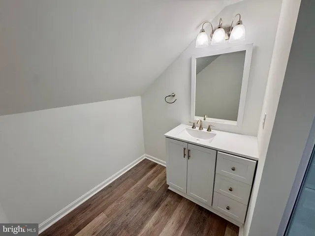 a bathroom with a sink mirror and vanity