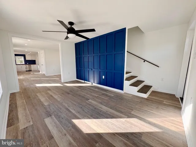 a view of a livingroom with a hall and wooden floor