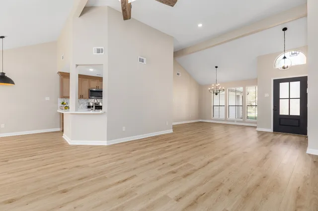 a view of a kitchen with wooden floor and a sink