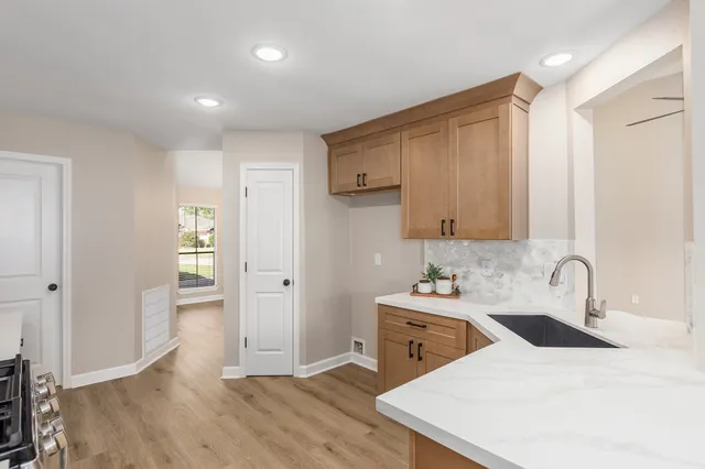 a room with a sink a bed and a mirror