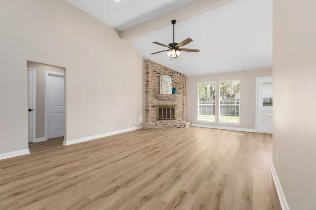wooden floor in an empty room with a window