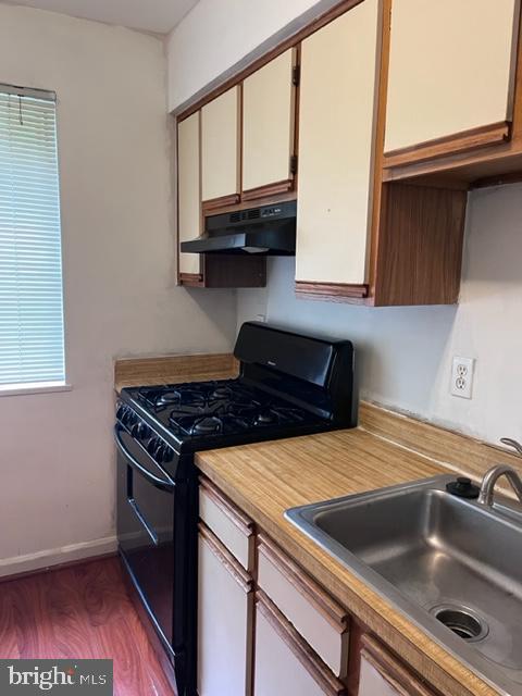 4721 1st Street Southwest, Unit 101 Washington, DC 20032 - Photo 5 of 15 a kitchen with a stove microwave and sink