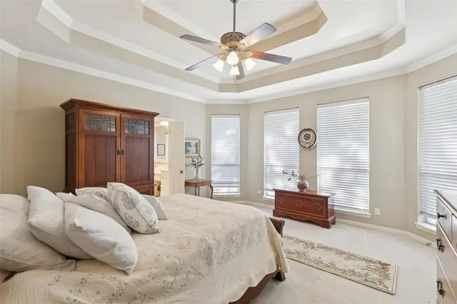 a spacious bedroom with a bed and a chandelier