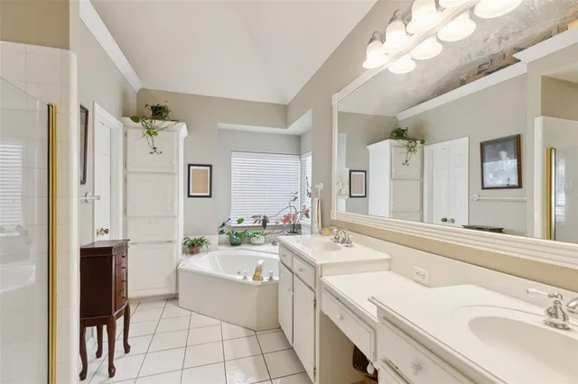 a bathroom with a granite countertop sink mirror and a bathtub