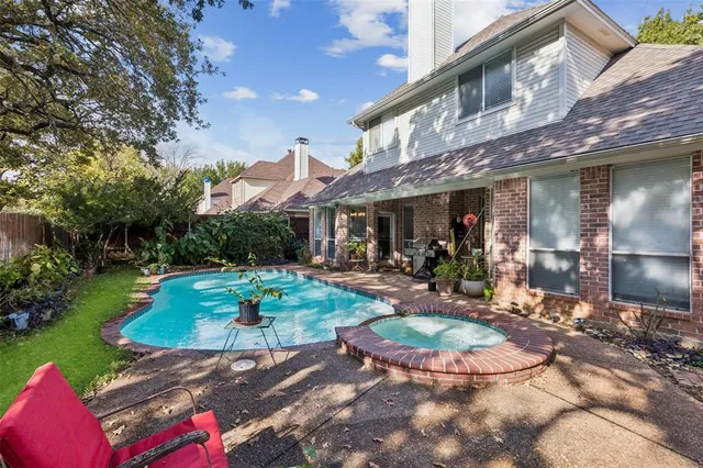 a view of a chairs and table in backyard of house