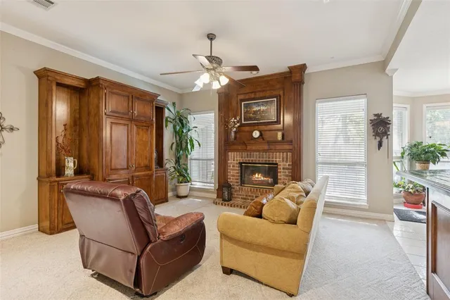 a living room with furniture a fireplace and a chandelier