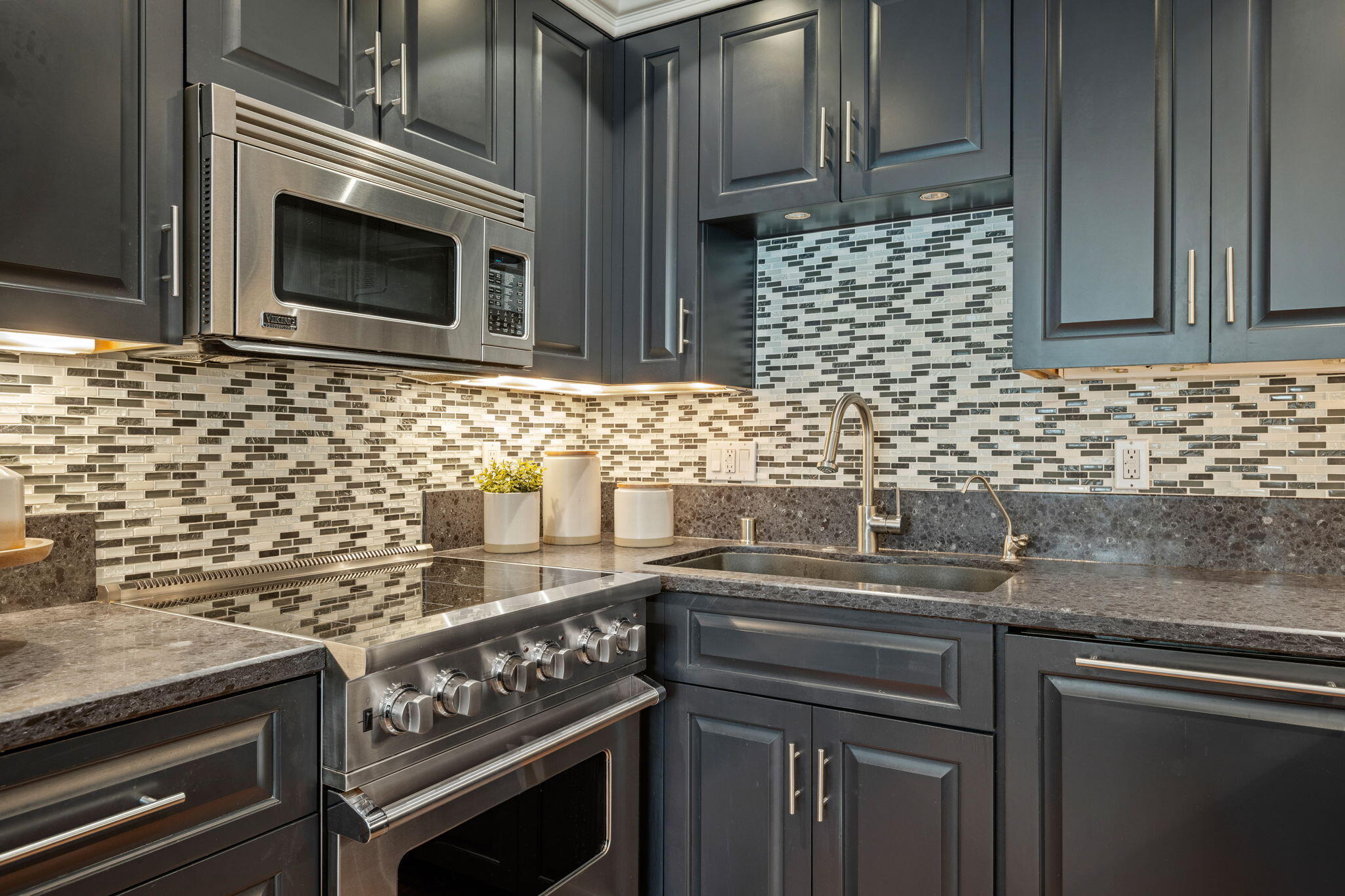 1701 Anacapa Street, Unit 9 Santa Barbara, CA 93101 - Photo 11 of 28 a kitchen with granite countertop a stove sink and microwave