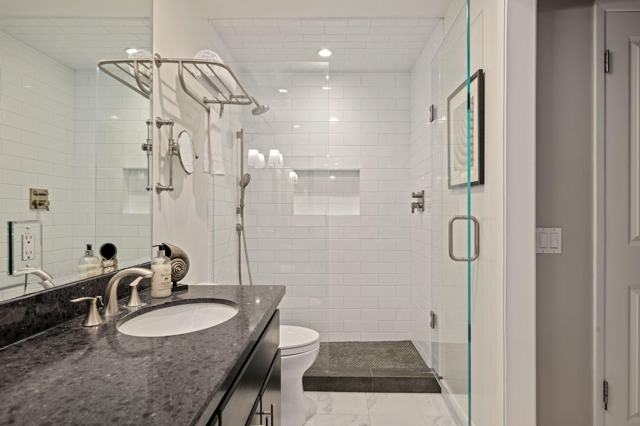 1701 Anacapa Street, Unit 9 Santa Barbara, CA 93101 - Photo 17 of 28 a bathroom with a granite countertop sink a mirror and shower