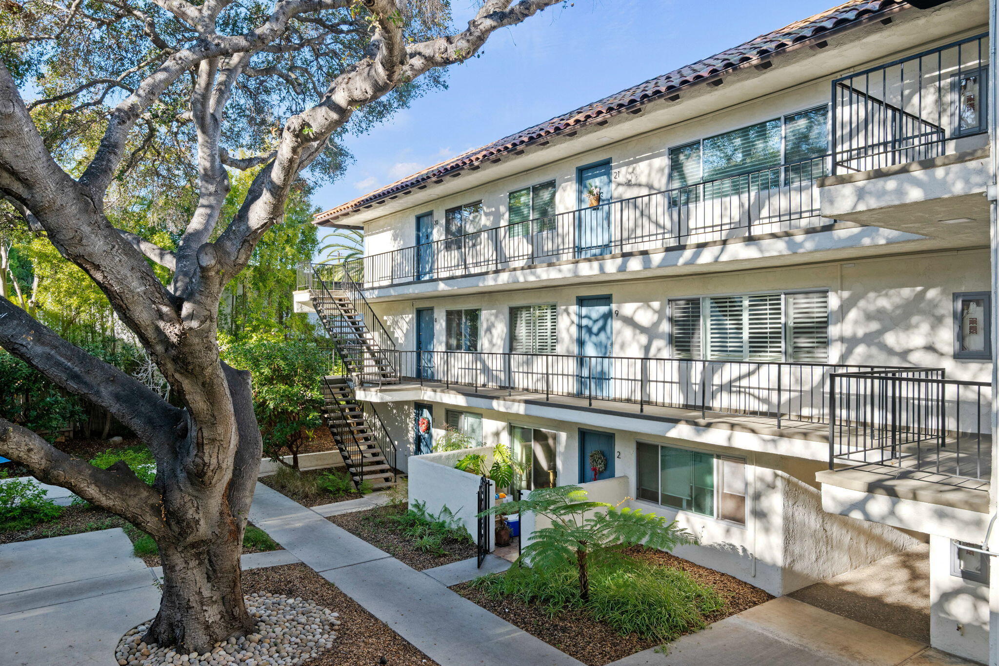 1701 Anacapa Street, Unit 9 Santa Barbara, CA 93101 - Photo 24 of 28 a front view of a building with a garden and plants