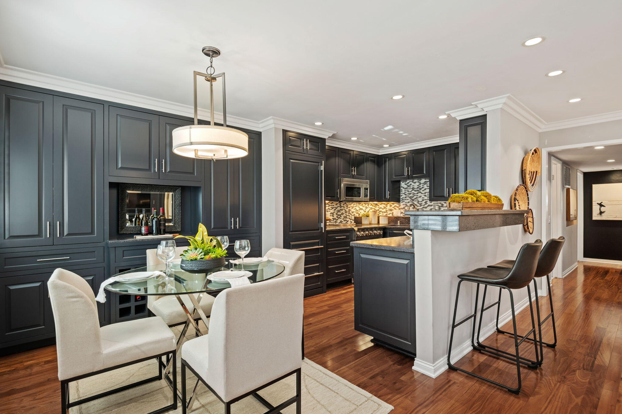 1701 Anacapa Street, Unit 9 Santa Barbara, CA 93101 - Photo 9 of 28 a kitchen with stainless steel appliances kitchen island granite countertop a refrigerator a stove a sink dishwasher a dining table and chairs with wooden floor