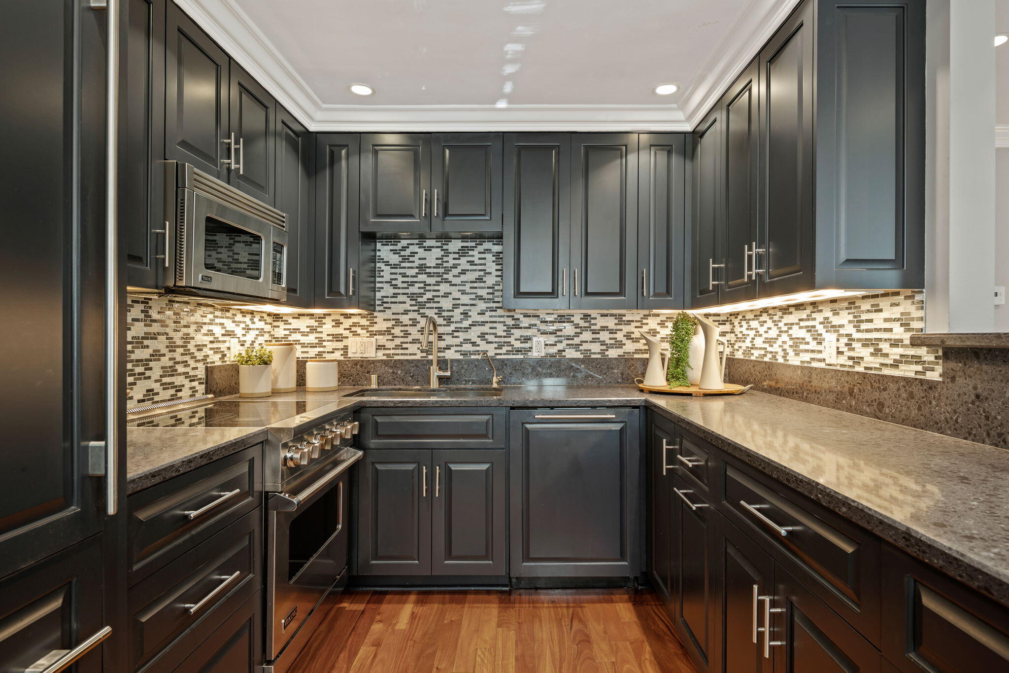 1701 Anacapa Street, Unit 9 Santa Barbara, CA 93101 - Photo 10 of 28 a kitchen with stainless steel appliances granite countertop wooden cabinets and a stove top oven