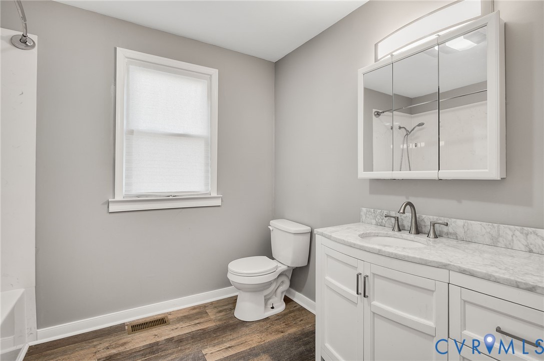 2313 Gordon Street Hopewell, VA 23860 - Photo 16 of 30 a bathroom with a toilet sink and mirror