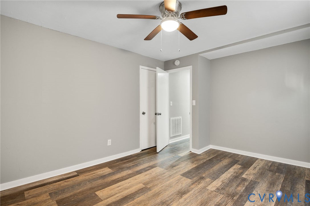 2313 Gordon Street Hopewell, VA 23860 - Photo 18 of 30 an empty room with wooden floor and ceiling fan