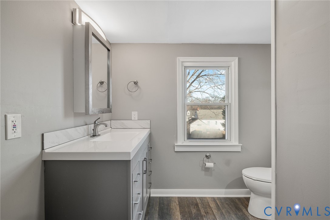 2313 Gordon Street Hopewell, VA 23860 - Photo 22 of 30 a bathroom with a toilet a sink and mirror