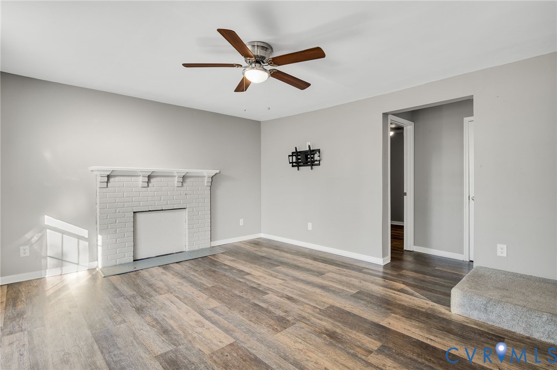 2313 Gordon Street Hopewell, VA 23860 - Photo 5 of 30 a view of a livingroom with wooden floor and a ceiling fan
