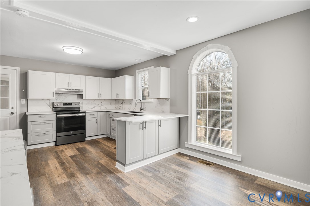 2313 Gordon Street Hopewell, VA 23860 - Photo 8 of 30 a kitchen with white cabinets and appliances