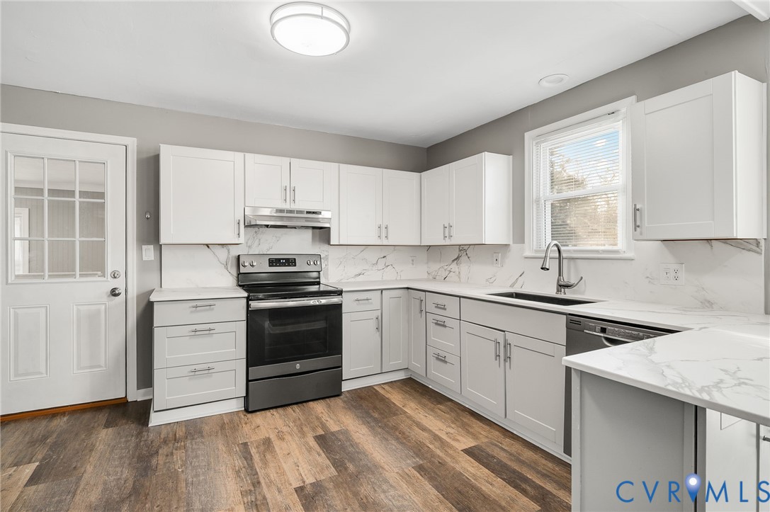 2313 Gordon Street Hopewell, VA 23860 - Photo 9 of 30 a kitchen with a sink stove and cabinets