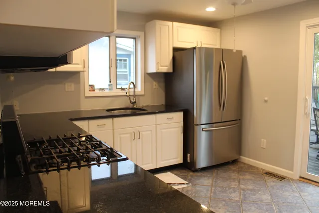 a kitchen with stainless steel appliances a refrigerator and a stove top oven