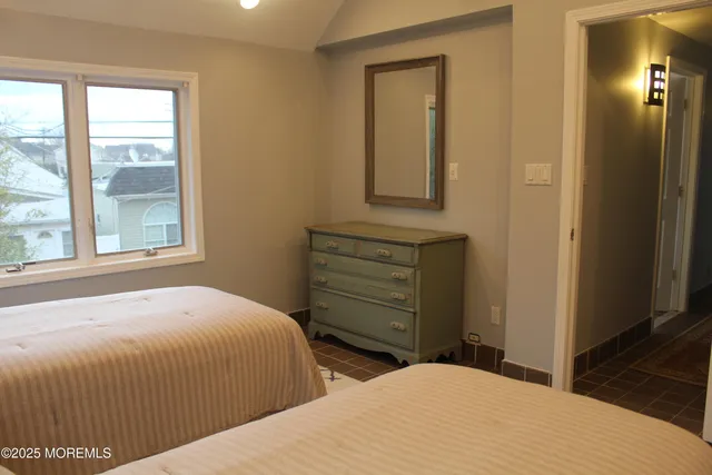 a bedroom with a bed and a mirror