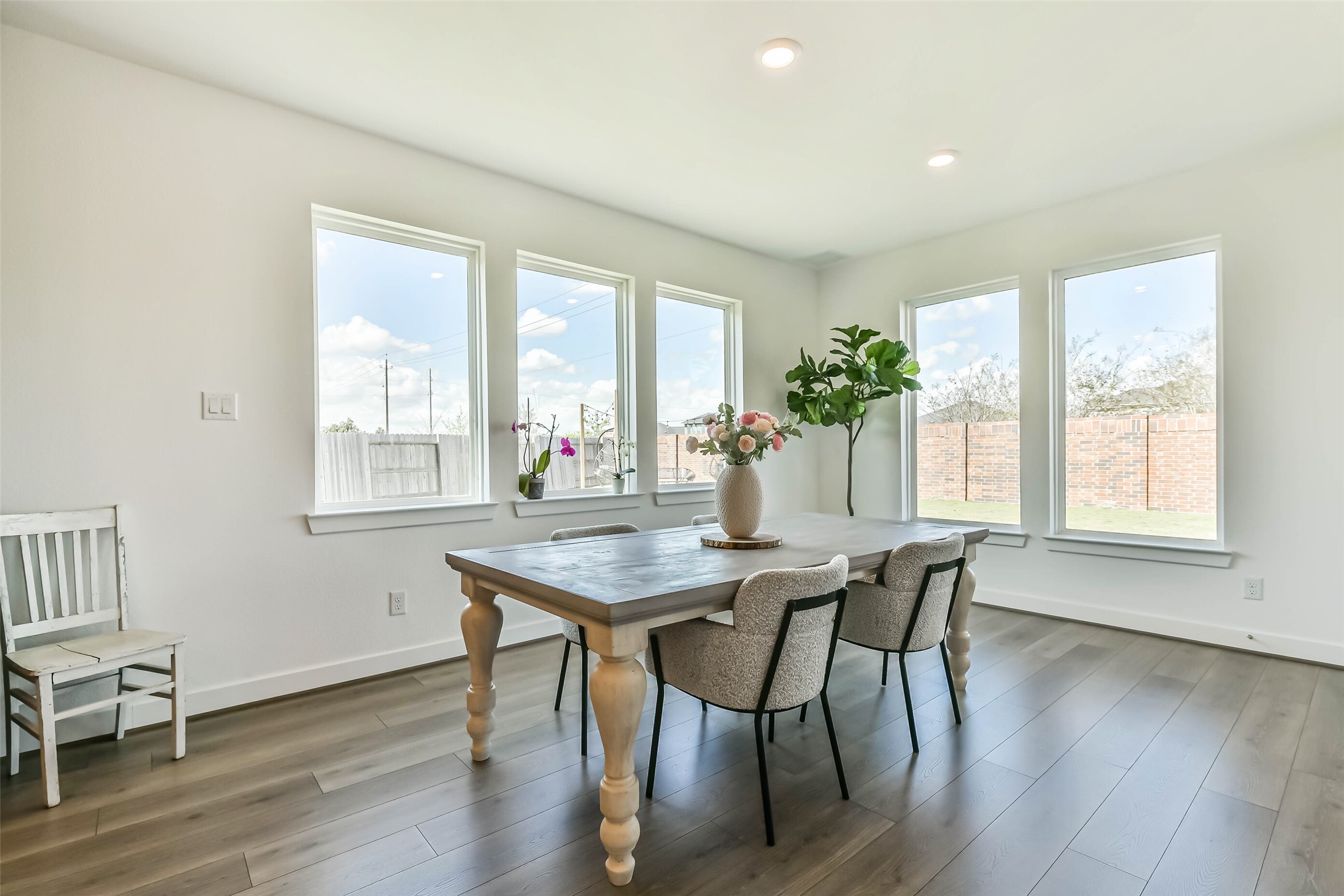 1612 Dayton Rdg Circle Friendswood, TX 77546 - Photo 14 of 50 Bright dining area with large windows, and a spacious table. Natural light enhances the airy, open feel.