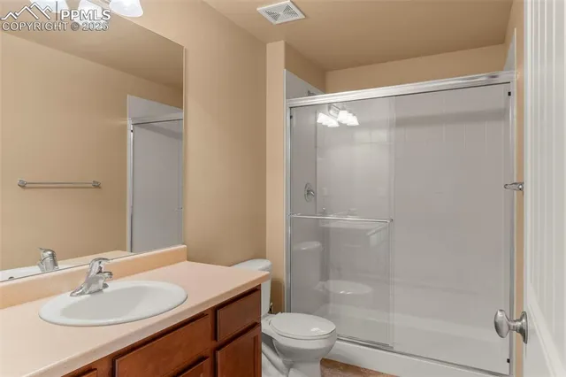 a view of a garage with wooden floor and white walls