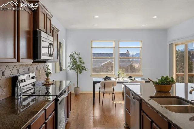 a kitchen with a table chairs stove and cabinets
