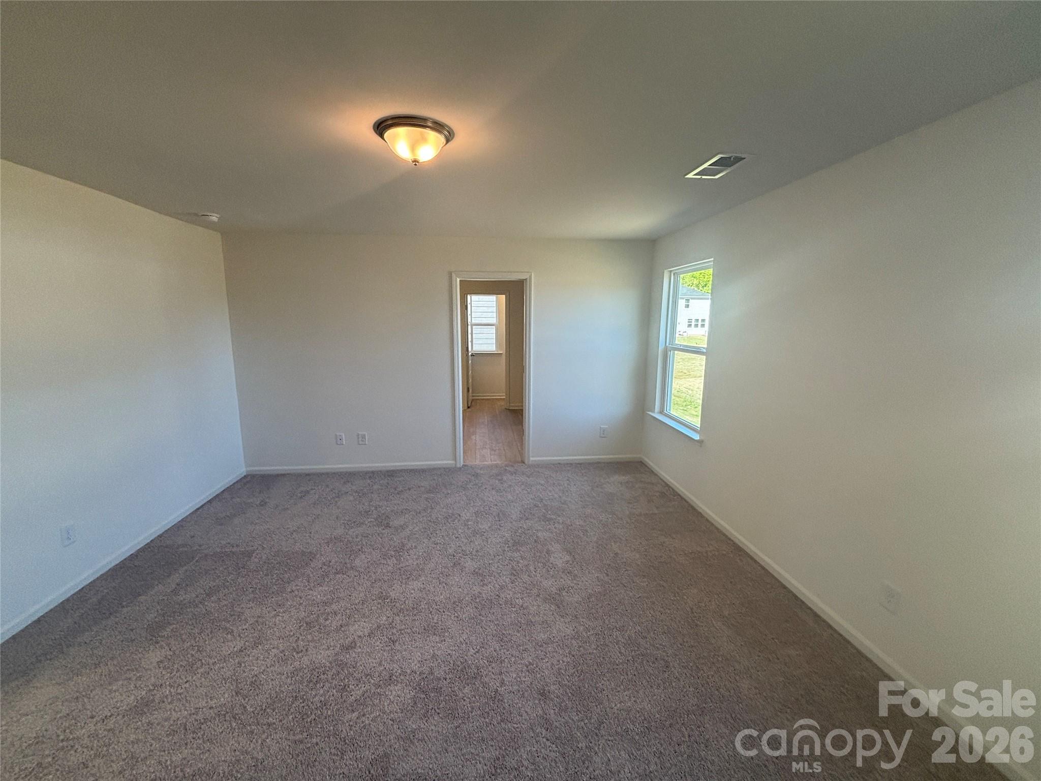 357 Roxanna Lane, Unit 72 York, SC 29745 - Photo 13 of 23 a view of an empty room with window and wooden floor