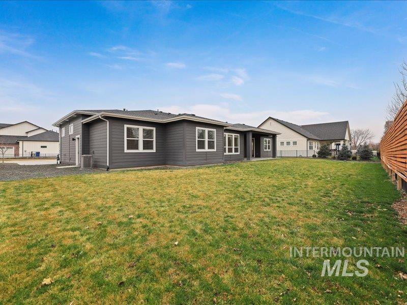 3882 West Haverhill Street Eagle, ID 83616 - Photo 39 of 41 Back of house with a lawn and a patio area