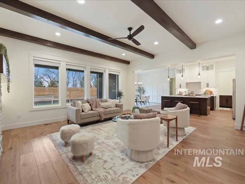 3882 West Haverhill Street Eagle, ID 83616 - Photo 7 of 41 Living area with light wood-style flooring, a ceiling fan, recessed lighting, and beam ceiling