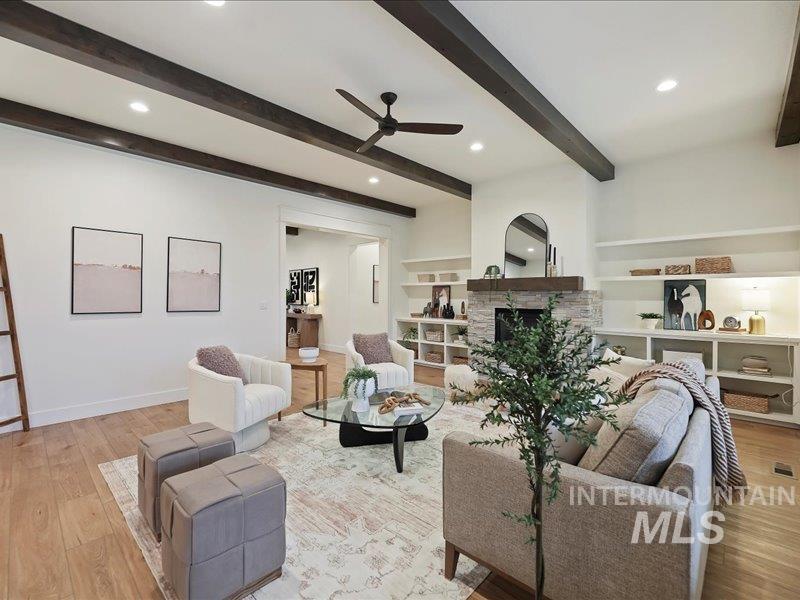 3882 West Haverhill Street Eagle, ID 83616 - Photo 10 of 41 Living room featuring light wood-style floors, a ceiling fan, a fireplace, beamed ceiling, and recessed lighting