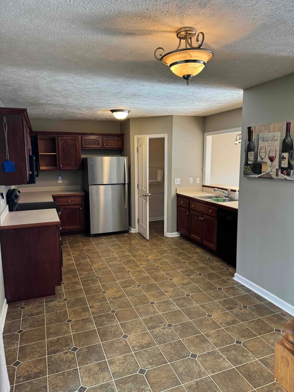 a kitchen with a stove and a refrigerator