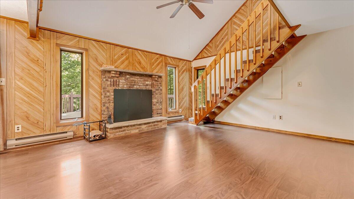 5913 Decker Road Bushkill, PA 18324 - Photo 12 of 53 a view of an empty room with stairs wooden floor and windows