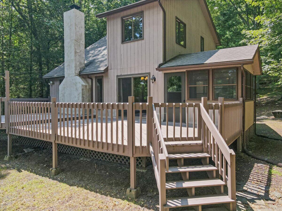 5913 Decker Road Bushkill, PA 18324 - Photo 5 of 53 a front view of a house with a garden