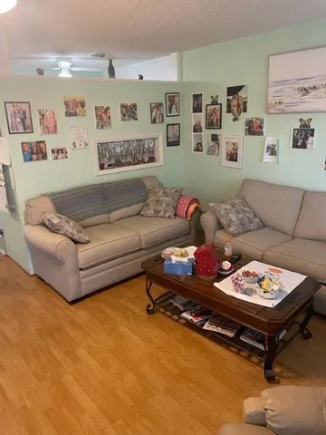 a living room with furniture and painting on the wall