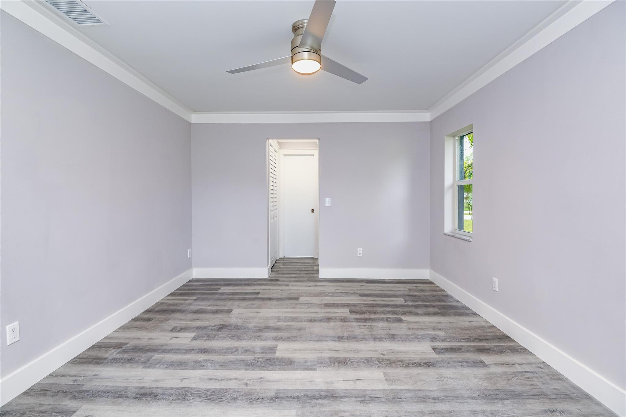 22500 Labrador Street Boca Raton, FL 33428 - Photo 18 of 30 a view of an empty room with window and wooden floor