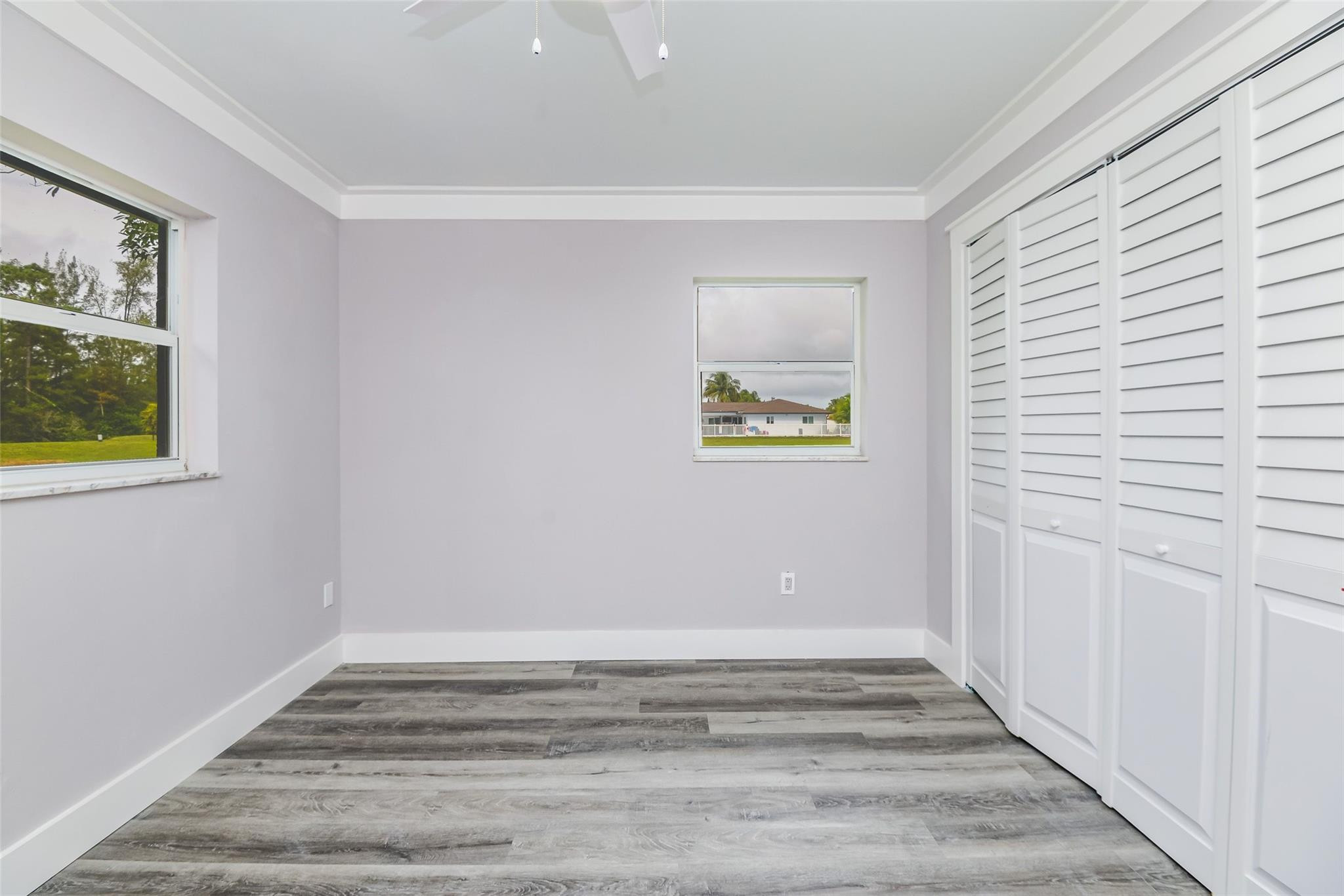 22500 Labrador Street Boca Raton, FL 33428 - Photo 24 of 30 a view of an empty room with wooden floor and a window