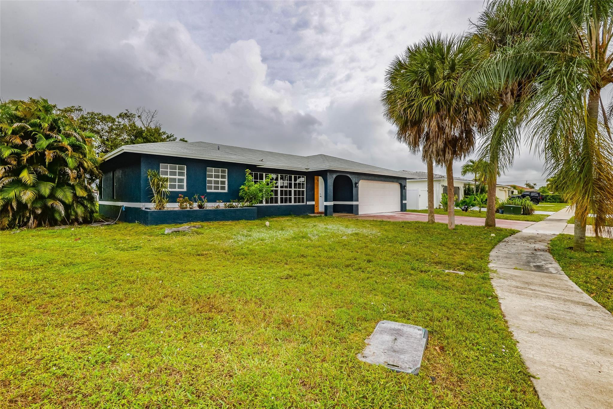 22500 Labrador Street Boca Raton, FL 33428 - Photo 3 of 30 a front view of a house with swimming pool and trees in the background