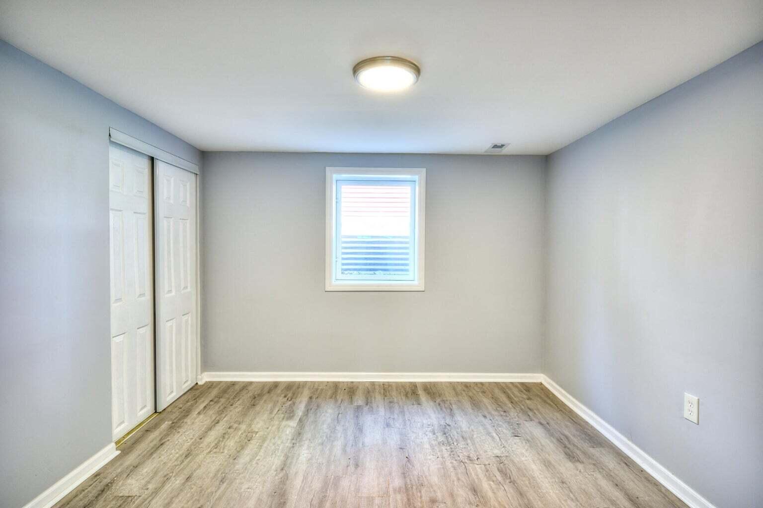 1330 Taney Place Gary, IN 46404 - Photo 12 of 19 an empty room with wooden floor and windows