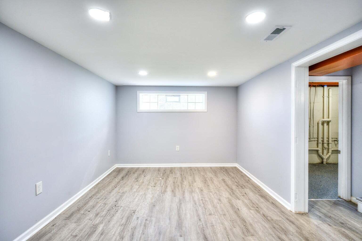 1330 Taney Place Gary, IN 46404 - Photo 14 of 19 an empty room with wooden floor and windows