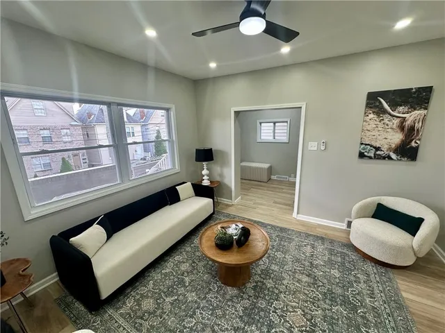 a view of a dining room with furniture and a potted plant