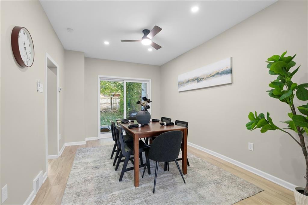 411 Kambach Street Pittsburgh, PA 15211 - Photo 14 of 47 Spacious Dining Room features high ceilings, recessed lighting, excellent natural light, remote ceiling fan, luxury plank vinyl flooring (throughout the home), and sliding glass doors leading out to rear backyard deck/greemspace!