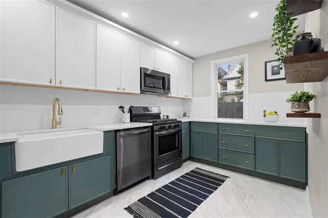 a kitchen with a sink cabinets and window