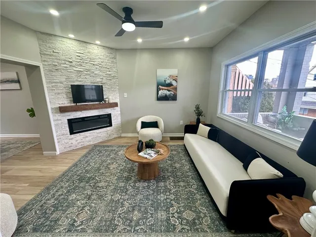a living room with furniture and a large window